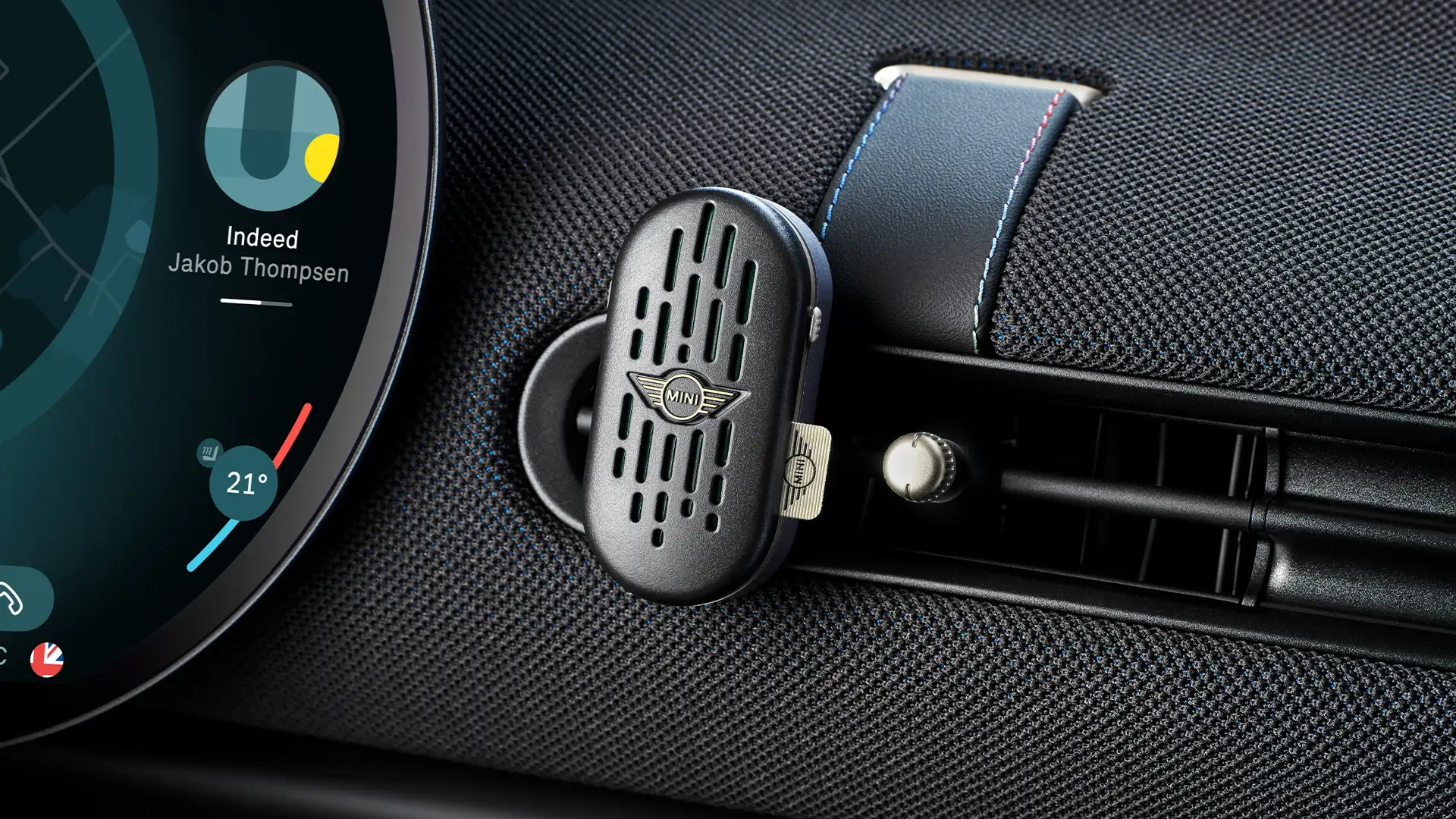 MINI Aceman interior with circular OLED infotainment touchscreen and MINI natural air freshener on dash