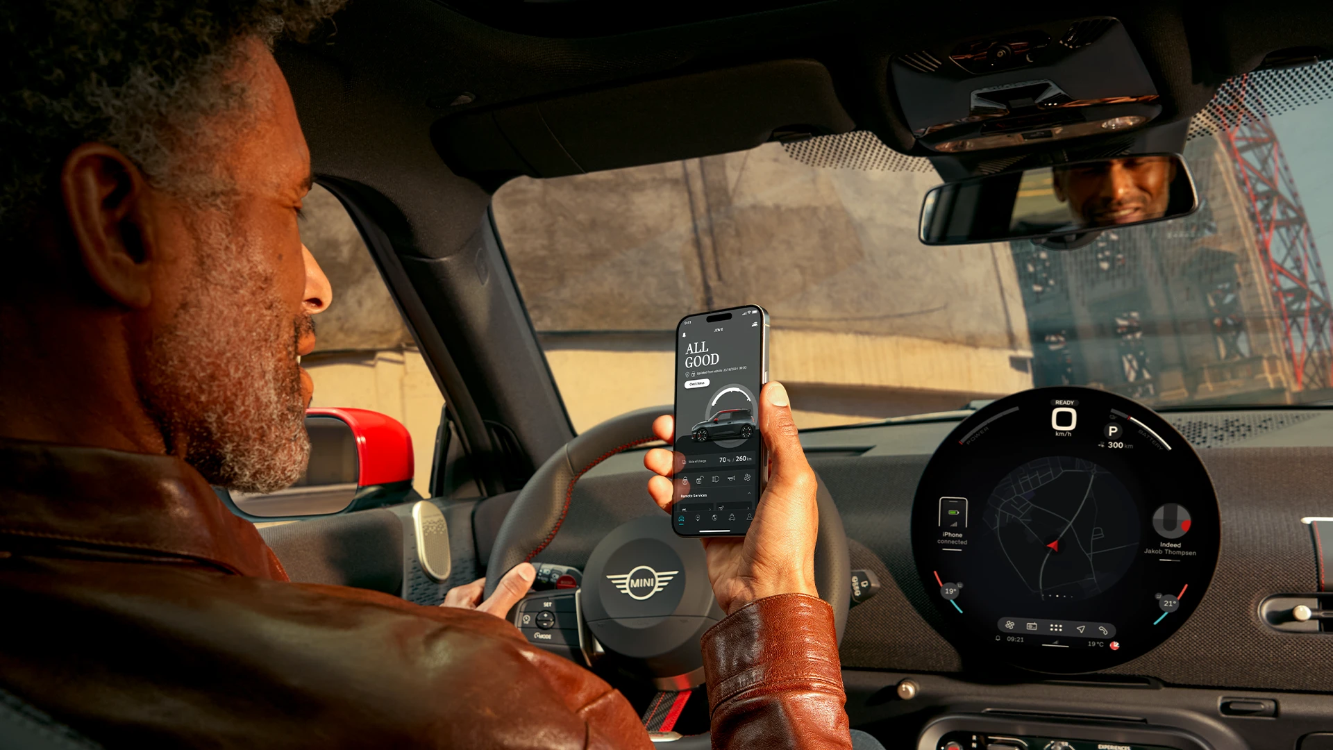 MINI driver using MINI App in his phone for navigation services.